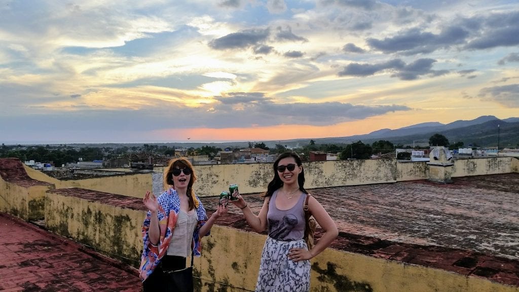 Cheersing beers on a rooftop in Cuba - A Week in Cuba